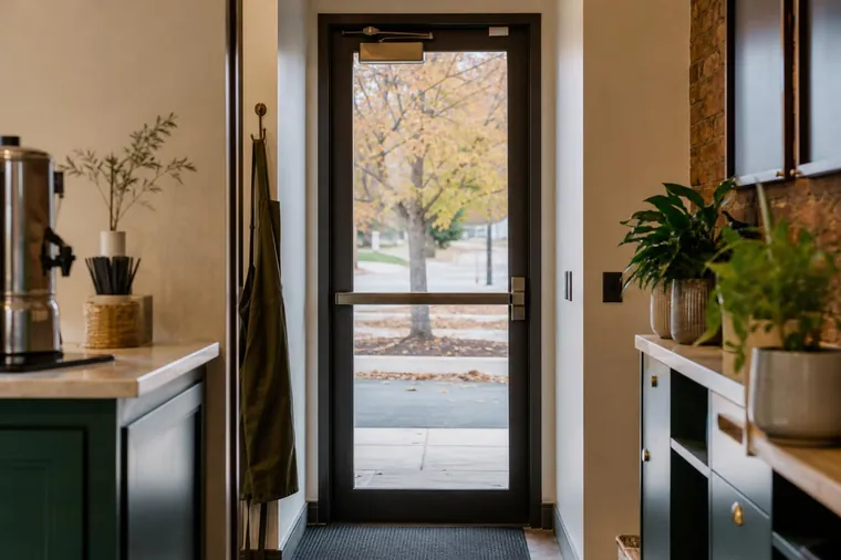 Business exit door with a push bar and a door closer