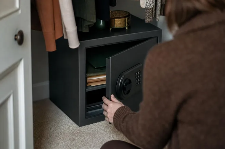 Small home safe with its door open in a closet